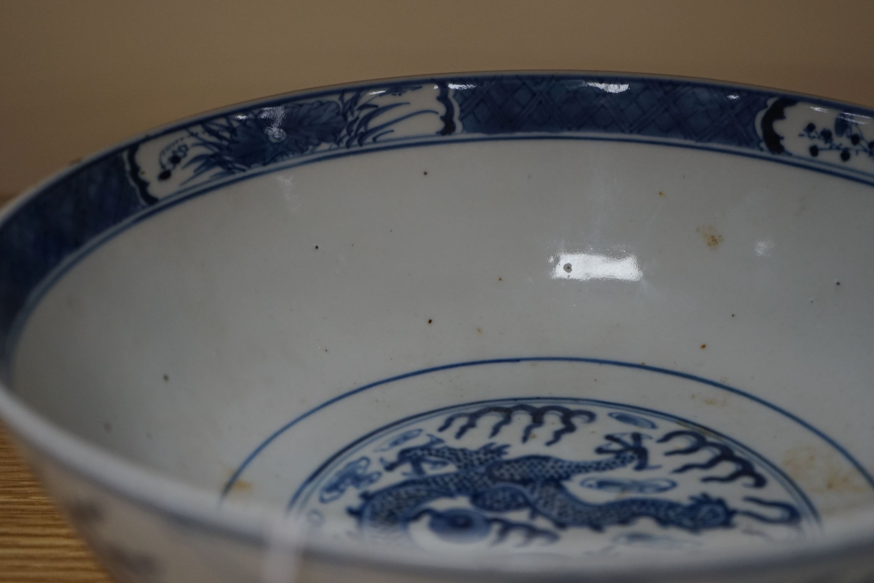 A Chinese blue and white ‘dragon’ bowl, Kangxi mark, late 19th century 25cm